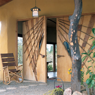 Architect Darrel DeBoer designed and built these pivot-mounted doors of lightweight honeycomb with inlays of local hardwoods that eliminate almost all visible hardware.